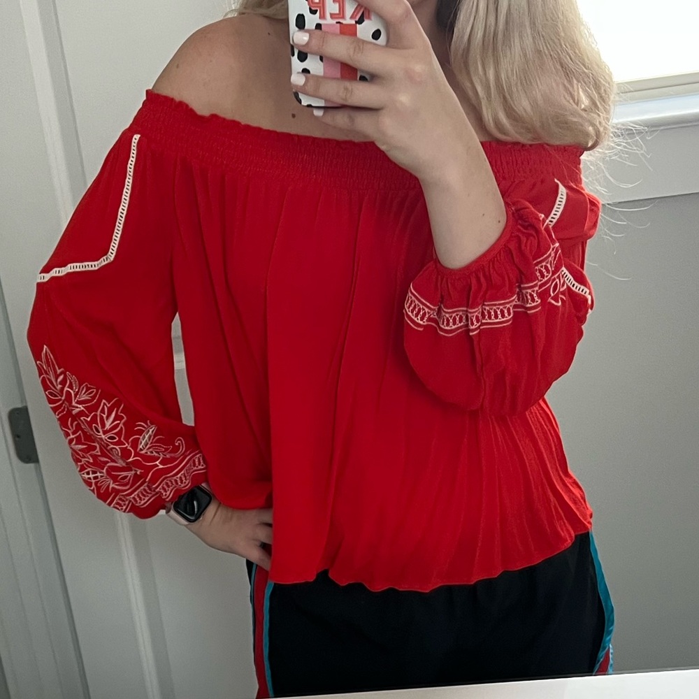 Orange/red top with white crochet. Size M. Worn once. Can be on or off shoulder.